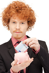 Image showing man with piggy bank and money