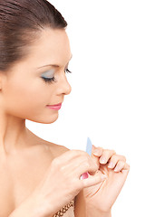 Image showing beautiful woman polishing her nails