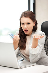 Image showing unhappy woman with computer and euro cash money