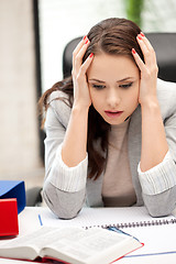 Image showing worried woman with book