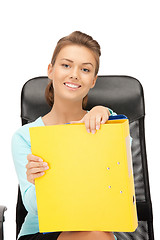 Image showing young businesswoman with folders sitting in chair