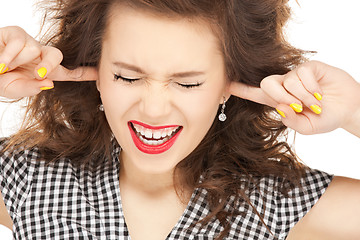 Image showing woman with fingers in ears