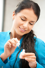 Image showing beautiful woman polishing her nails