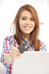 Image showing happy woman with laptop computer and credit card