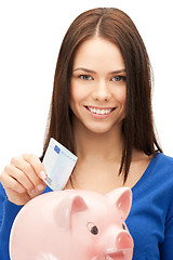 Image showing lovely woman with piggy bank and money