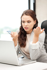 Image showing unhappy woman with computer and euro cash money