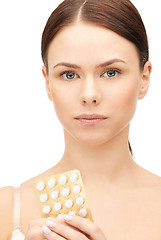 Image showing young beautiful woman with pills