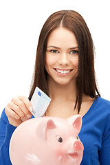 Image showing lovely woman with piggy bank and money