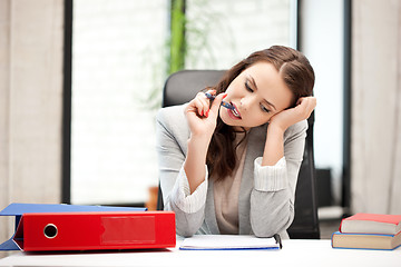 Image showing pensive woman with big notepad