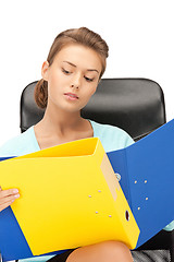 Image showing young businesswoman with folders sitting in chair