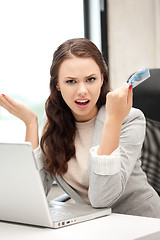 Image showing unhappy woman with computer and euro cash money