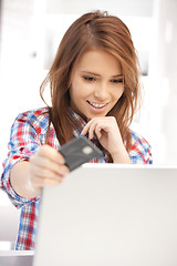 Image showing happy woman with laptop computer and credit card