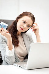 Image showing pensive woman with computer and euro cash money