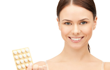 Image showing young beautiful woman with pills