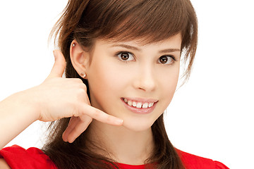 Image showing teenage girl making a call me gesture