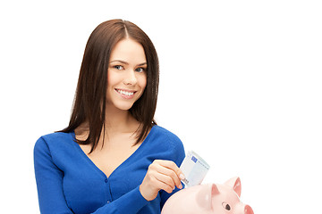 Image showing lovely woman with piggy bank and money