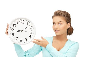 Image showing woman holding big clock