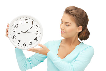 Image showing woman holding big clock