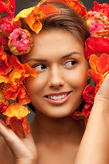 Image showing lovely woman with red flowers