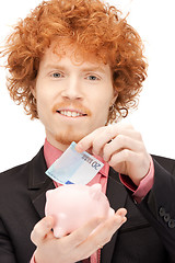 Image showing man with piggy bank and money