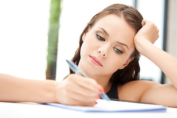 Image showing calm woman with big notepad