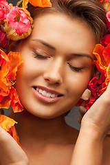 Image showing lovely woman with red flowers