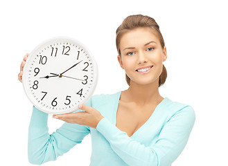 Image showing woman holding big clock