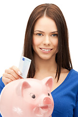 Image showing lovely woman with piggy bank and money