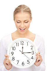 Image showing woman holding big clock