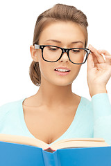 Image showing calm and serious woman with book