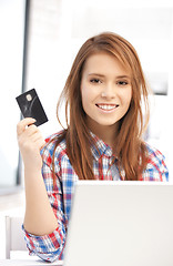 Image showing happy woman with laptop computer and credit card