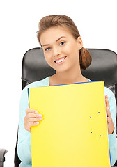 Image showing young businesswoman with folders sitting in chair