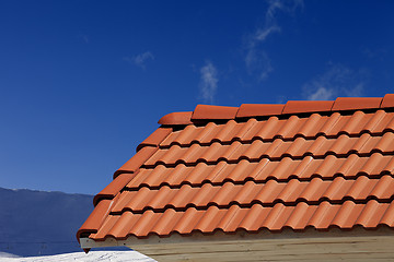 Image showing Roof tiles against ski slope in nice day