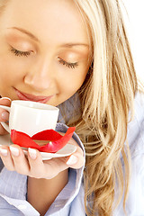 Image showing blond with cup of coffee and chocolate