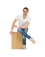 Image showing handsome man with big box