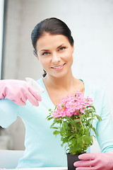 Image showing lovely housewife with flower