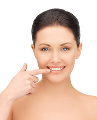 Image showing beautiful woman pointing to teeth