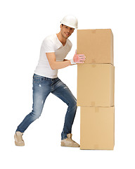 Image showing handsome builder moving big boxes