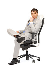 Image showing young businessman sitting in chair