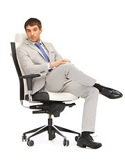 Image showing young businessman sitting in chair