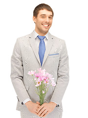 Image showing handsome man with flowers in hand