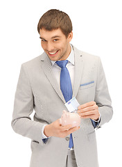Image showing man with piggy bank and money