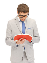 Image showing calm and serious man with book