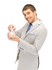 Image showing man with piggy bank and money