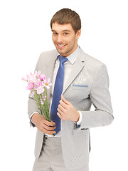 Image showing handsome man with flowers in hand