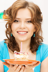 Image showing lovely housewife with cake and candle