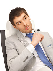 Image showing young businessman sitting in chair