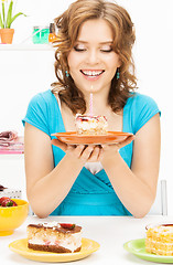 Image showing lovely housewife with cake and candle