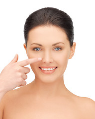 Image showing beautiful woman pointing to nose