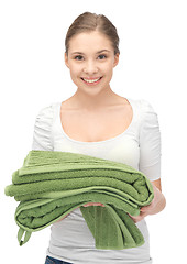 Image showing lovely housewife with towels